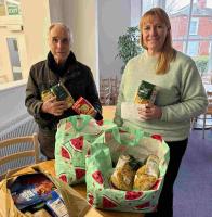 Martyn presenting food and a cheque to Lee